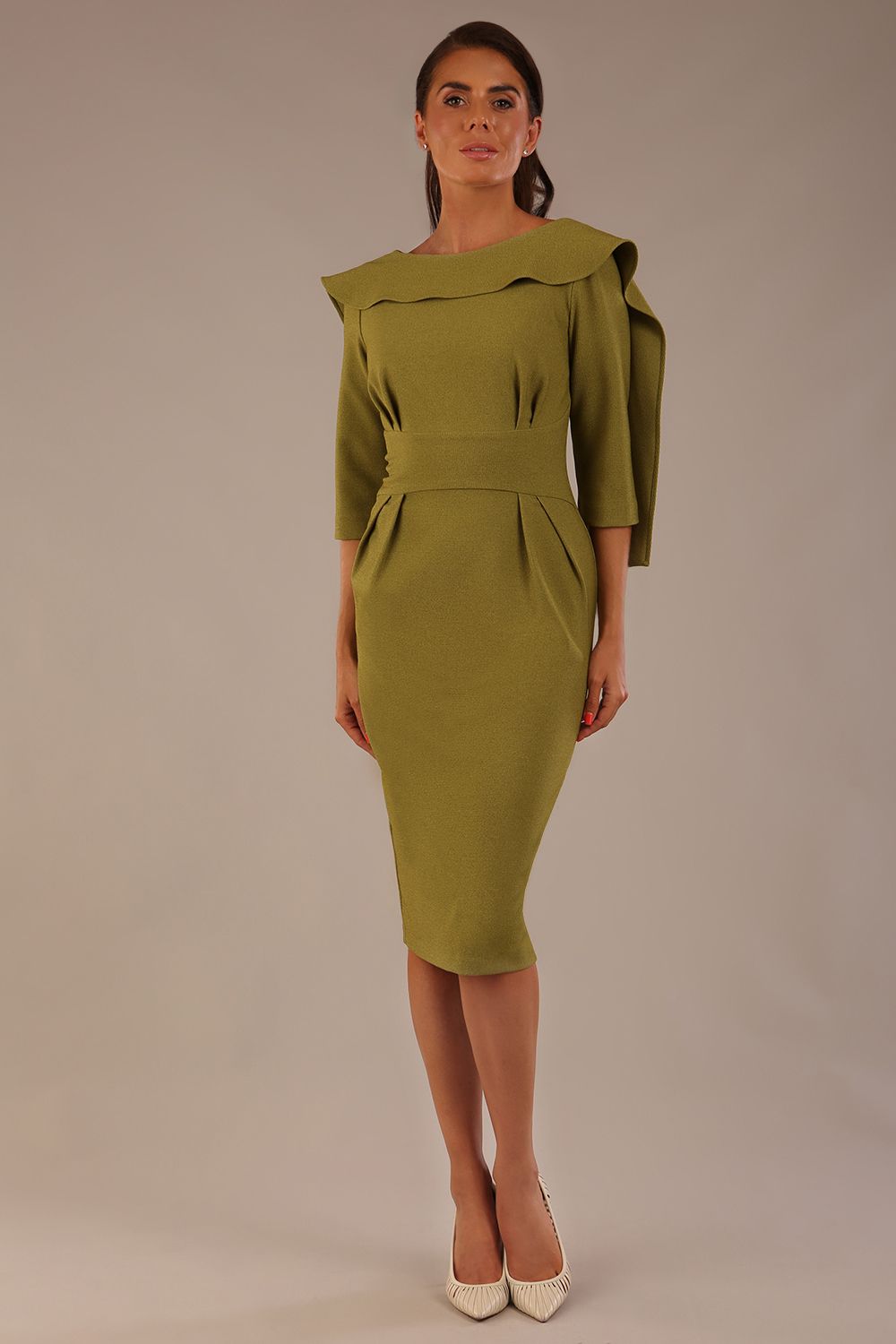 Model wearing the Rio statement collar pencil dress in oasis green, showcasing its architectural silhouette (Oasis Green)