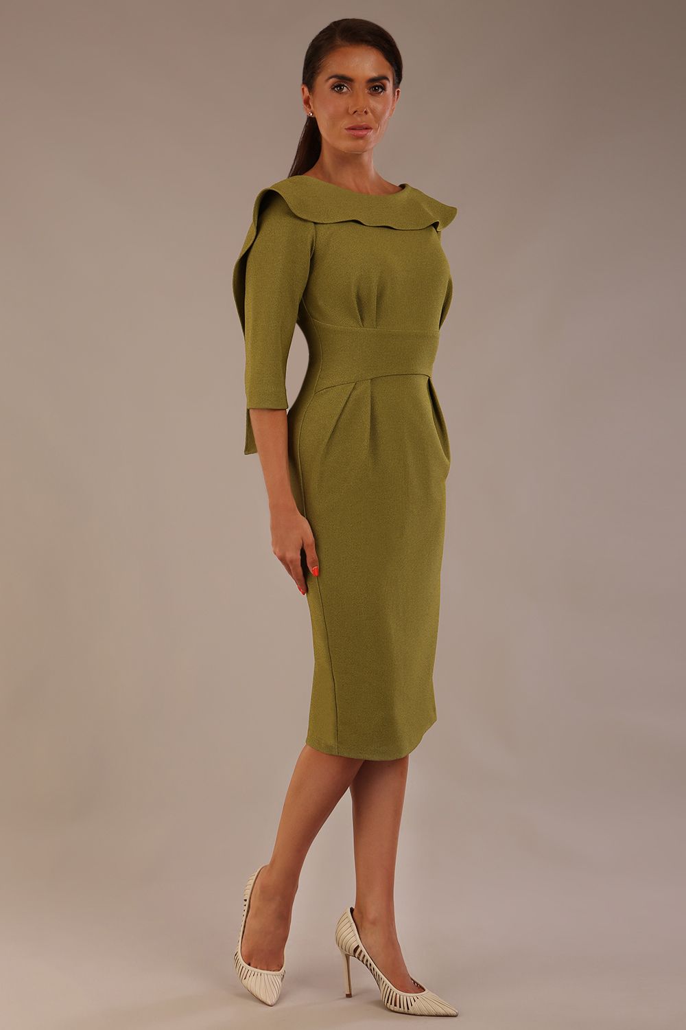 Model wearing the Rio statement collar pencil dress in oasis green, showcasing its architectural silhouette (Oasis Green)