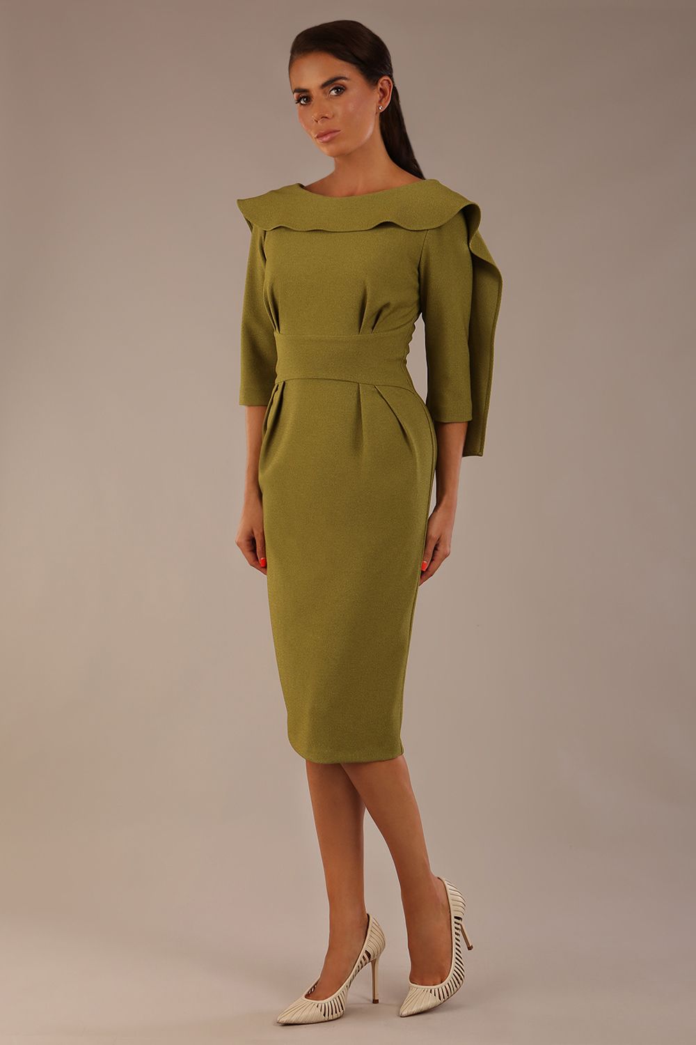 Model wearing the Rio statement collar pencil dress in oasis green, showcasing its architectural silhouette (Oasis Green)
