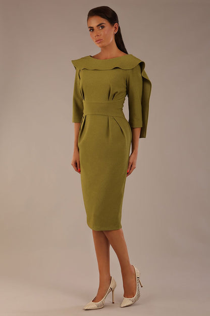 Model wearing the Rio statement collar pencil dress in oasis green, showcasing its architectural silhouette (Oasis Green)