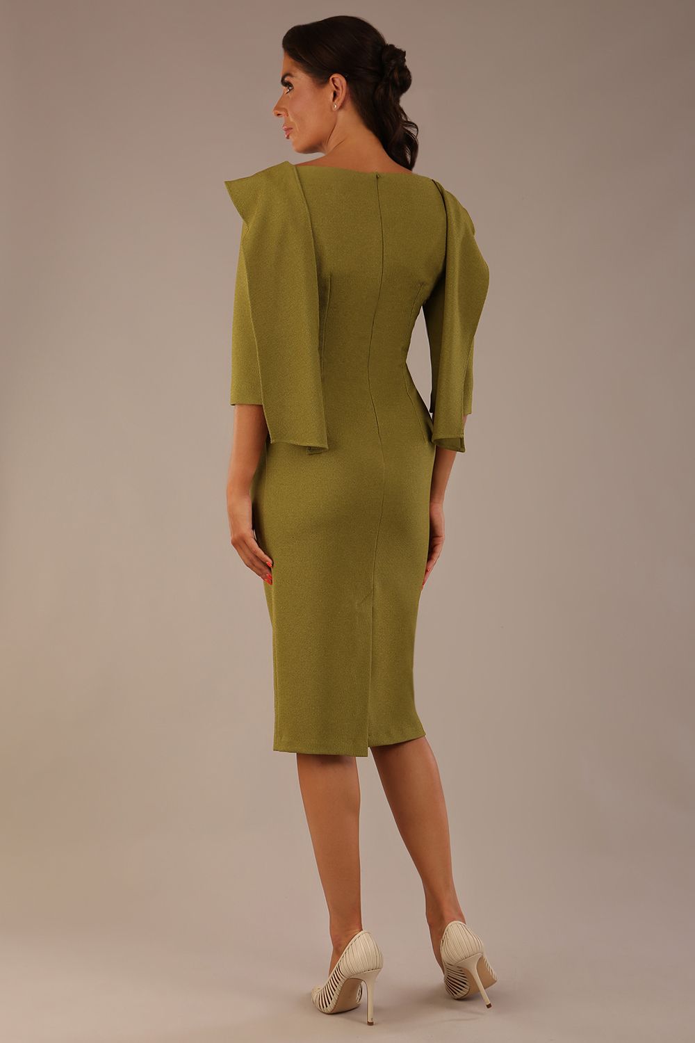 Model wearing the Rio statement collar pencil dress in oasis green, showcasing its architectural silhouette (Oasis Green)