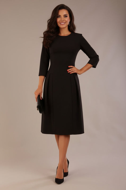 Model wearing the Ario pleated A-line dress in black, showcasing the round neckline and 3/4 sleeves (Black)
