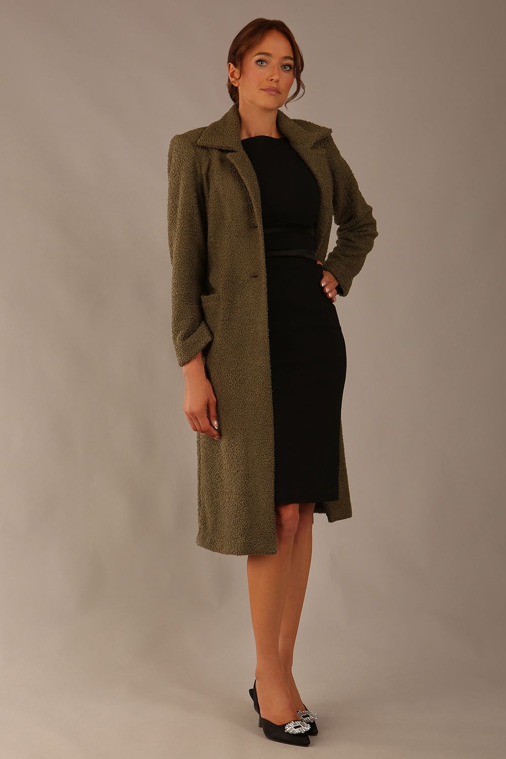 Model wearing the Ambrose boucle midi coat in olive green, long sleeves teddy feeling with a collar neckline and 2 closure buttons at the front and pockets (Olive Green)