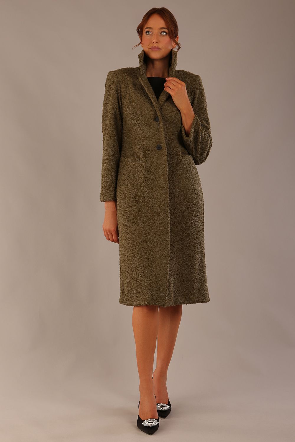 Model wearing the Ambrose boucle midi coat in olive green, long sleeves teddy feeling with a collar neckline and 2 closure buttons at the front and pockets (Olive Green)