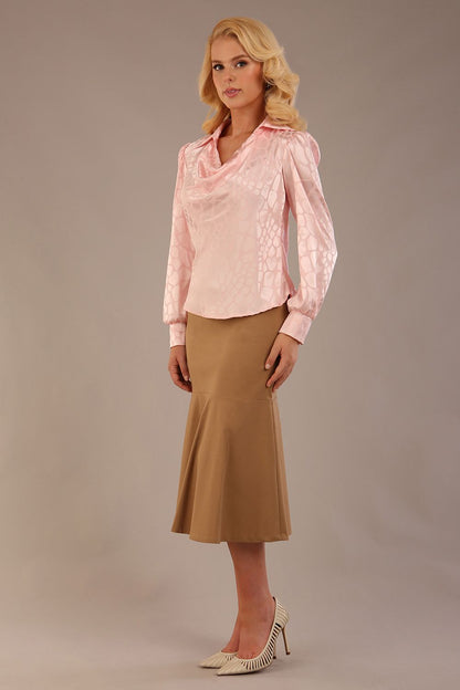 Blonde Model wearing the Shropshire top in pink, styled with a camel flared fishtail skirt (Pink)