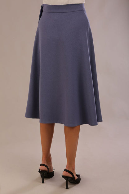Model wearing the Harlow A-line midi skirt in blue mineral, with the side-tie fastened in a bow (Blue Mineral)