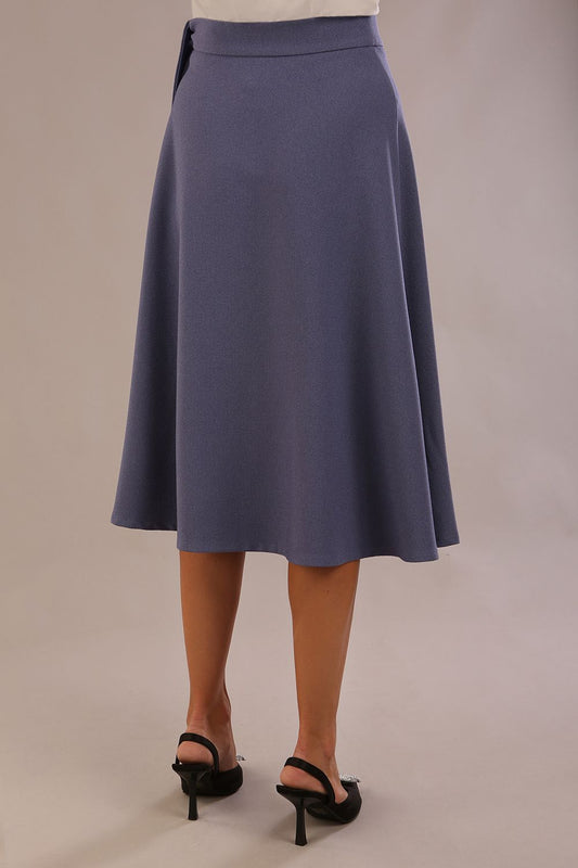 Model wearing the Harlow A-line midi skirt in blue mineral, with the side-tie fastened in a bow (Blue Mineral)