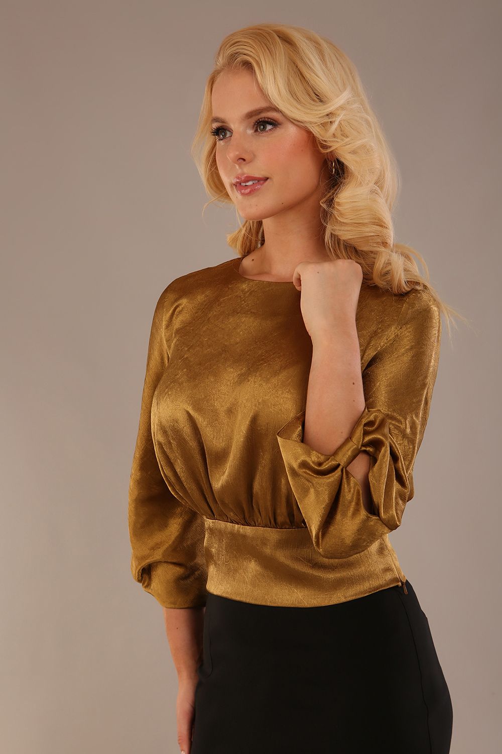 Model wearing a Hollywood lustre gold top with a blouson silhouette and a black pencil skirt close up (Rich Gold)