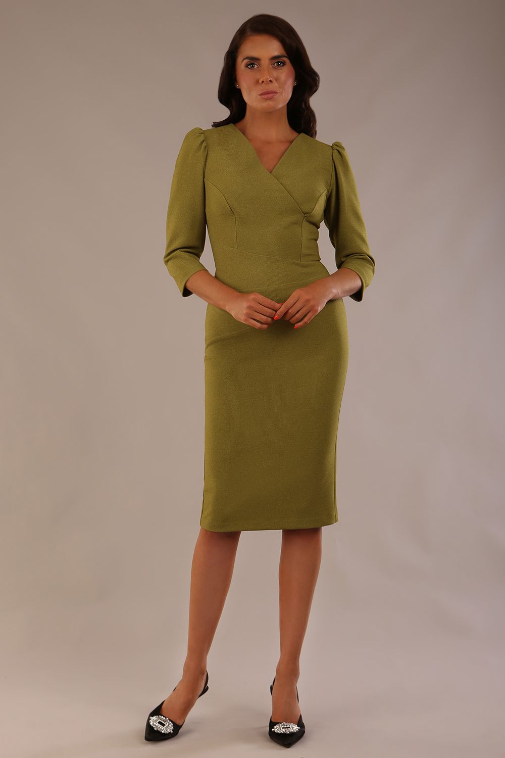 Model wearing an Ethan V-neck dress in oasis green, highlighting the flattering seams and puff shoulders (Oasis Green)
