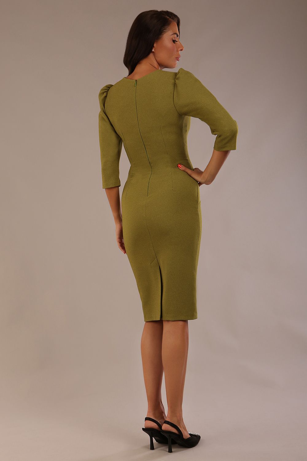 Model wearing an Ethan V-neck dress in oasis green, highlighting the flattering seams and puff shoulders (Oasis Green)