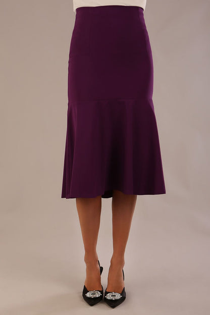 Model wearing the Truro floral top, showing the standard hip-length and draped V-neck and purple marlene skirt against a gray background (Purple)