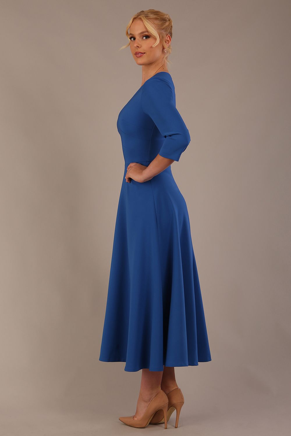 Woman wearing a blue dress against a plain background (Imperial Blue)