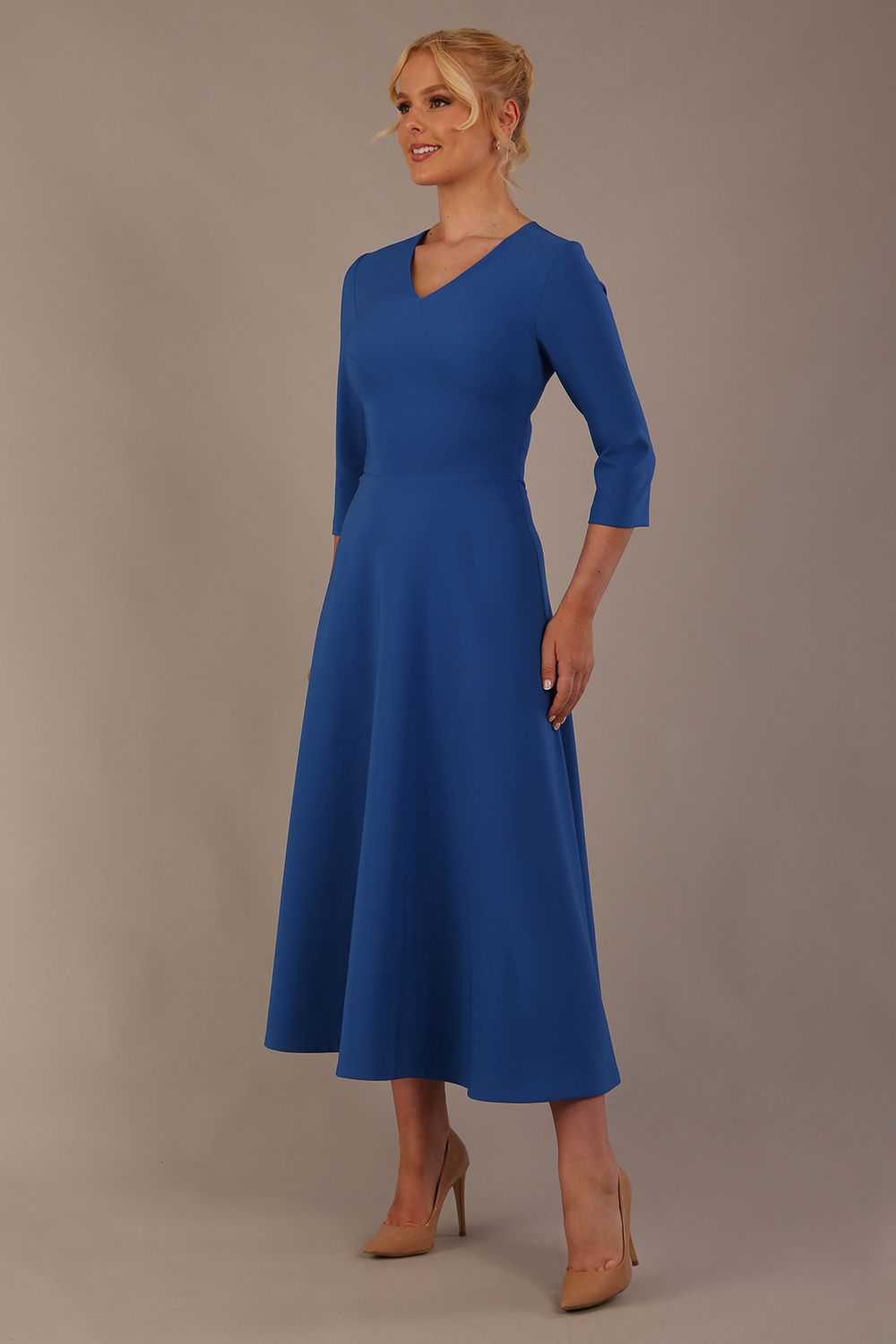 Woman wearing a blue dress against a plain background (Imperial Blue)