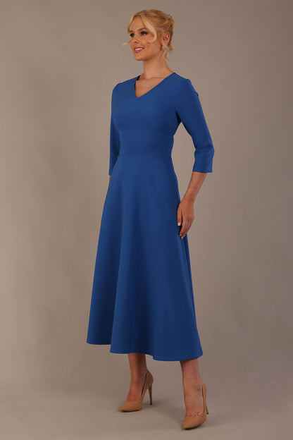 Woman wearing a blue dress against a plain background (Imperial Blue)