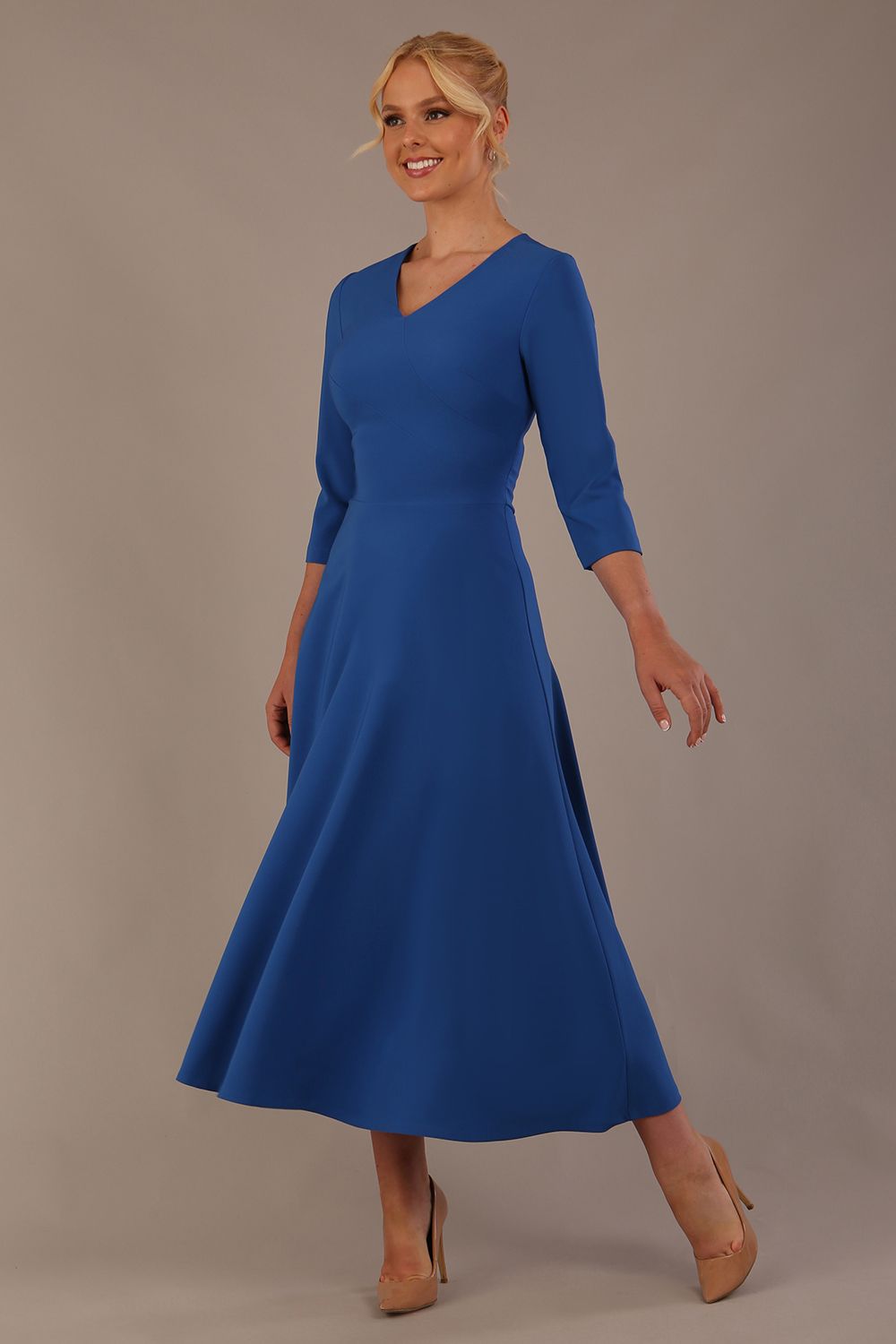 Woman wearing a blue dress against a plain background (Imperial Blue)