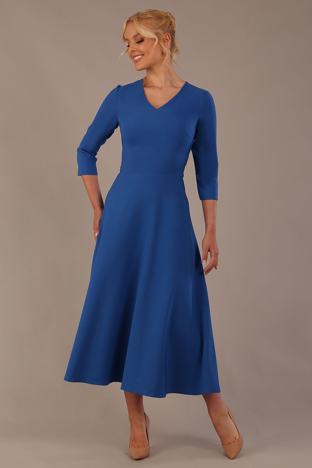 Woman wearing a blue dress against a plain background (Imperial Blue)