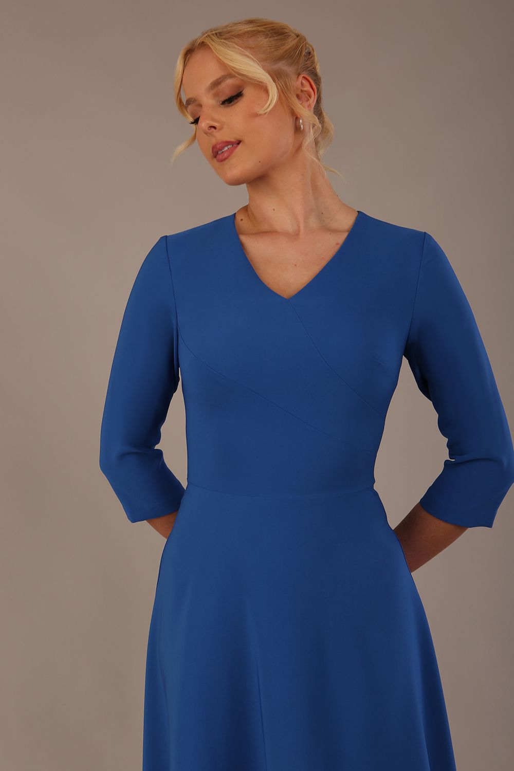 Woman wearing a blue dress against a plain background (Imperial Blue)