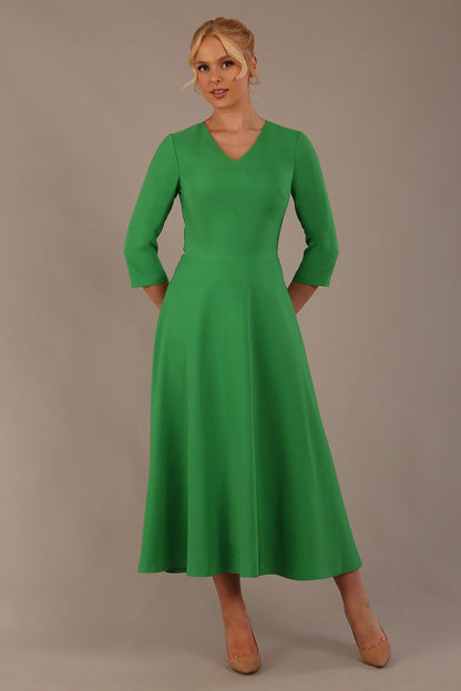  Model wearing the Nova V-neck A-line midaxi dress in vibrant (Jelly Bean Green)