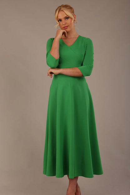  Model wearing the Nova V-neck A-line midaxi dress in vibrant (Jelly Bean Green)