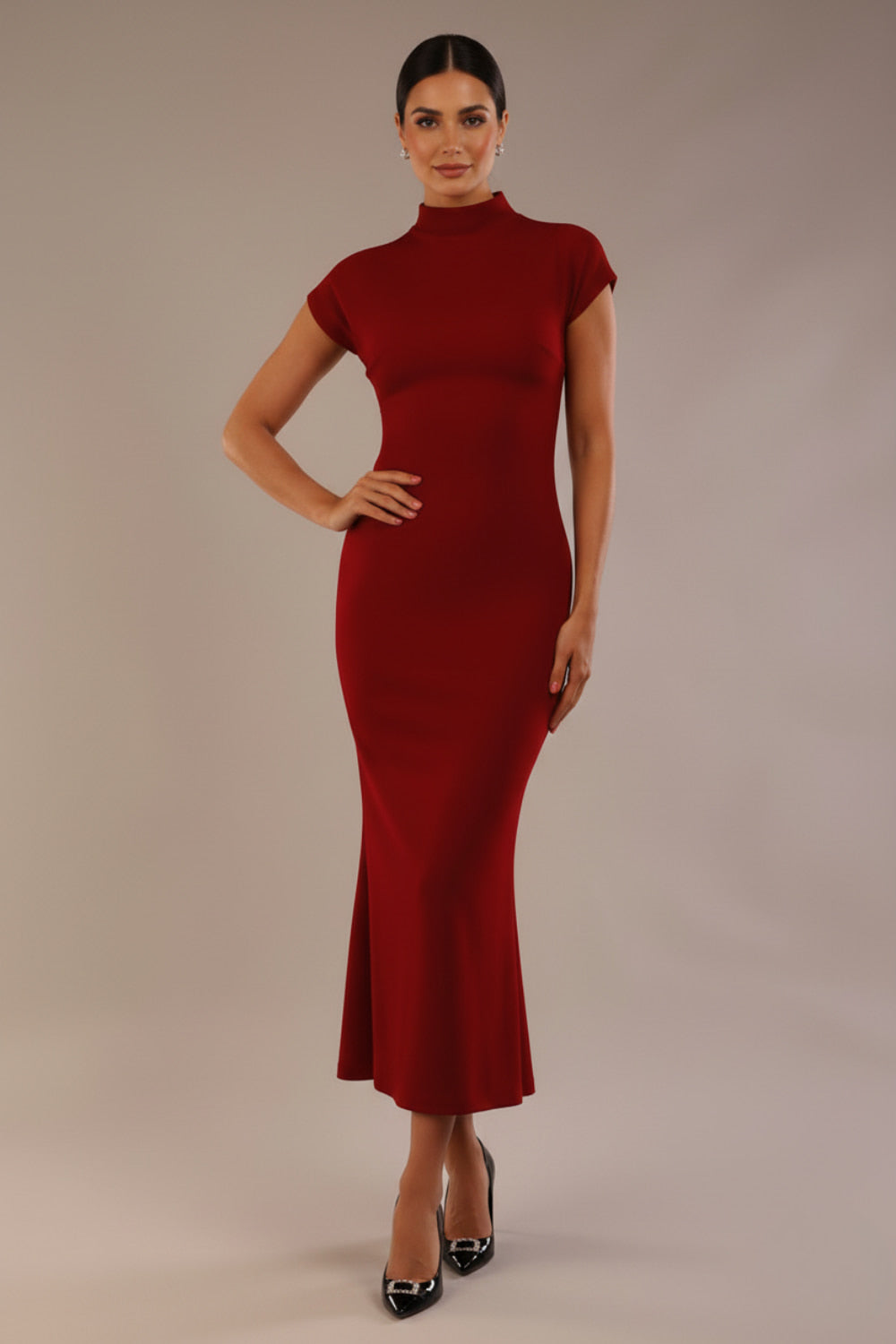 Model wearing the Kaden high neck midaxi dress in claret red, showing the sleek silhouette and cap sleeves against a plain background (Claret Red)