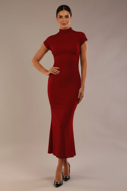 Model wearing the Kaden high neck midaxi dress in claret red, showing the sleek silhouette and cap sleeves against a plain background (Claret Red)