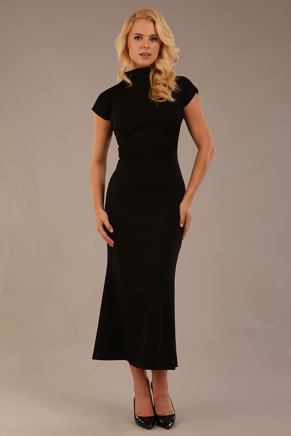 Model wearing the Kaden high neck midaxi dress in jet black, showing the sleek silhouette and cap sleeves. against a plain background (Jet Black)