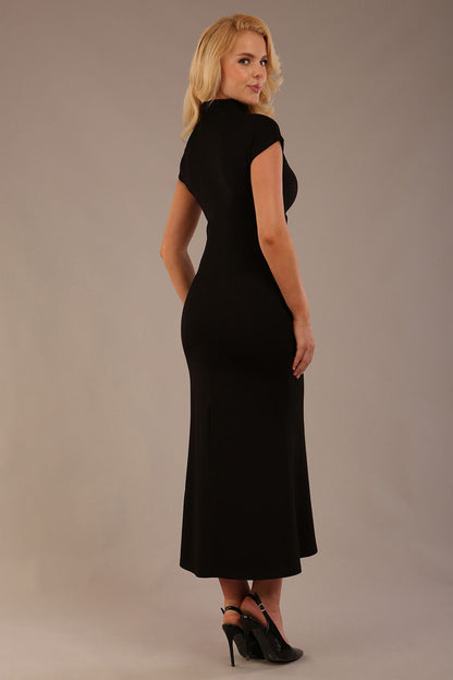 Model wearing the Kaden high neck midaxi dress in jet black, showing the sleek silhouette and cap sleeves. against a plain background (Jet Black)