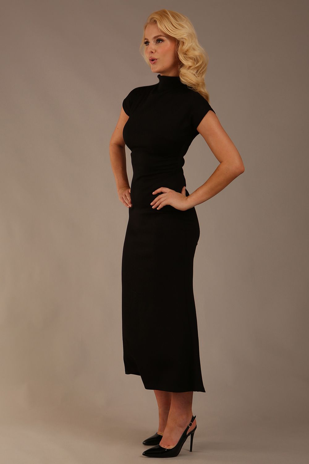 Model wearing the Kaden high neck midaxi dress in jet black, showing the sleek silhouette and cap sleeves. against a plain background (Jet Black)