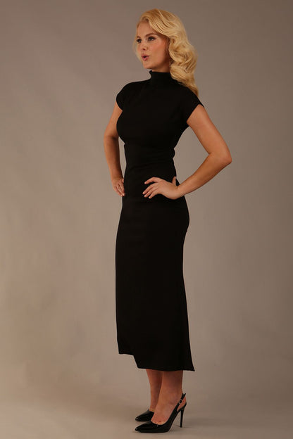 Model wearing the Kaden high neck midaxi dress in jet black, showing the sleek silhouette and cap sleeves. against a plain background (Jet Black)