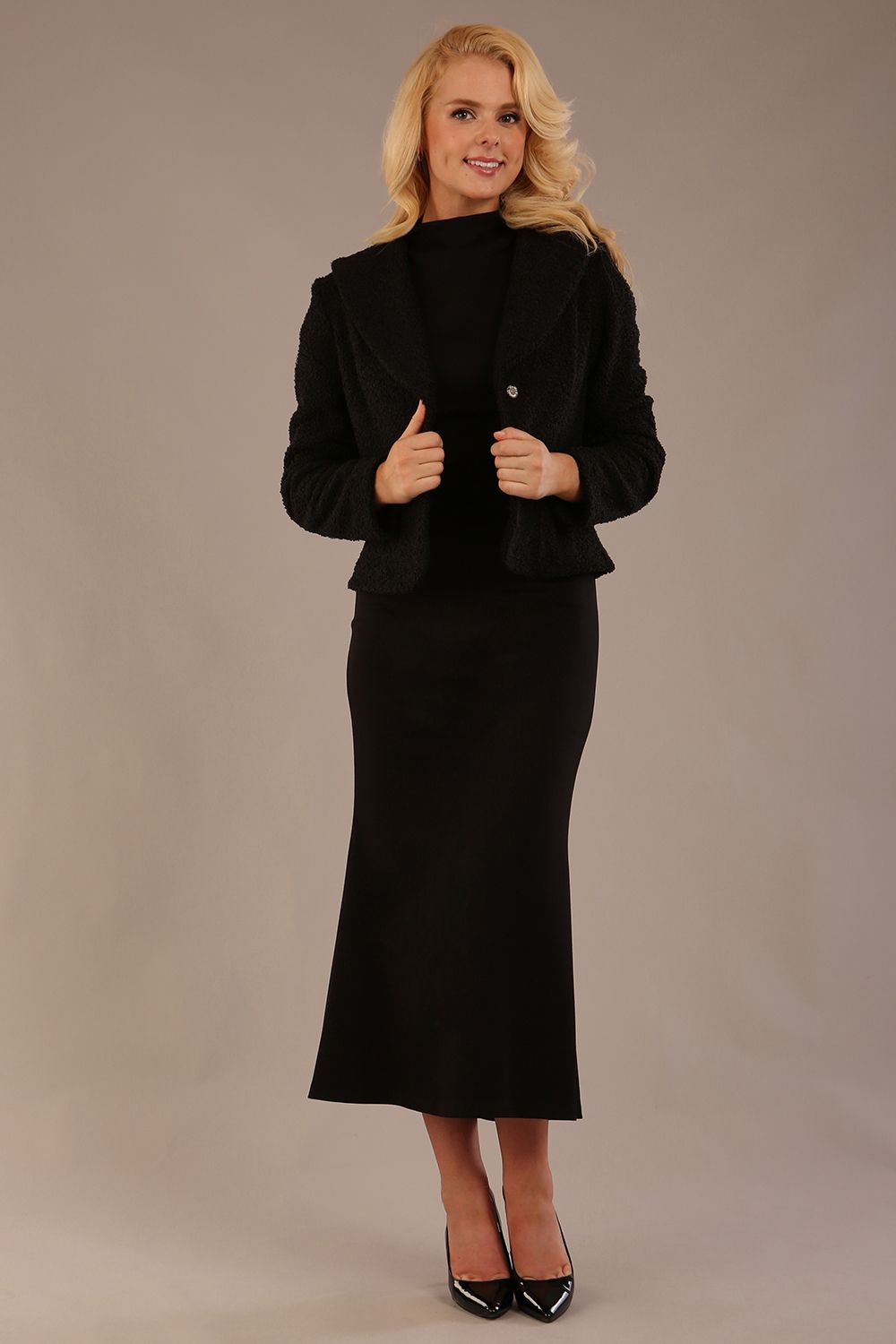 Model wearing the Teddy Luxe Boucle Jacket in black, showcasing its elegant shawl collar and textured fabric (Black)