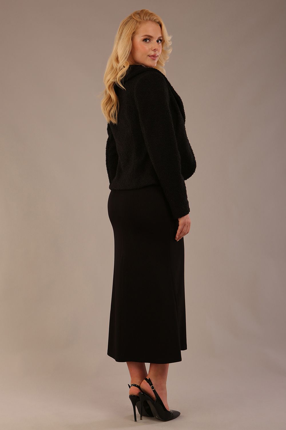 Model wearing the Teddy Luxe Boucle Jacket in black, showcasing its elegant shawl collar and textured fabric (Black)