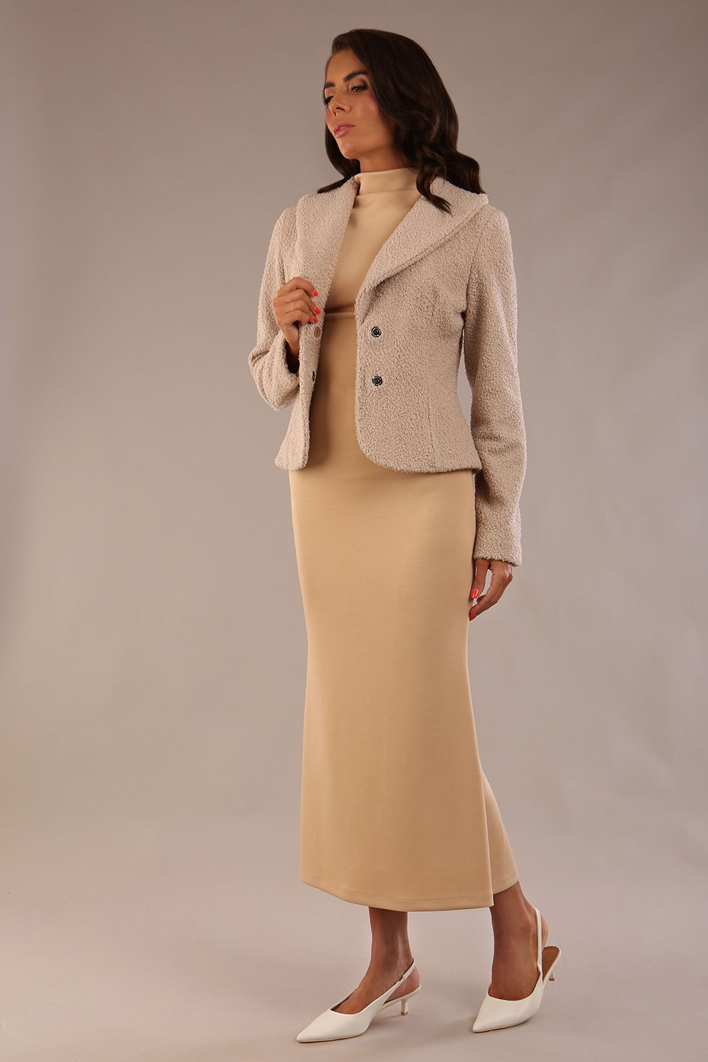 Model wearing the Teddy Luxe Boucle Jacket in pink tint, styled over a cream pencil dress close up (Pink Tint)