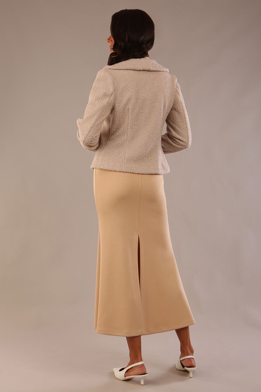 Model wearing the Teddy Luxe Boucle Jacket in pink tint, styled over a cream pencil dress close up (Pink Tint)