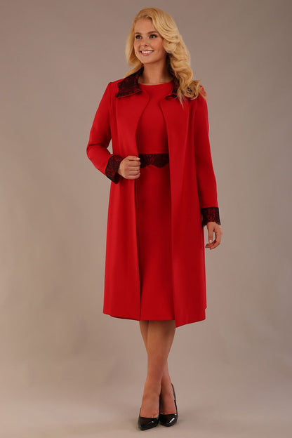 Model wearing the Haven lace trim midi coat in salsa red, styled with the matching Lovell dress (Salsa Red)