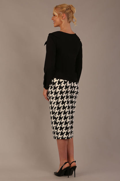 Woman sitting on a chair wearing a diva catwalk cressida black top and houndstooth-patterned skirt against a plain background (Houndstooth print)