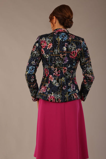 The Keanu floral jacket layered over a pink A-line dress for an elegant occasion look (Nightshade Bloom)