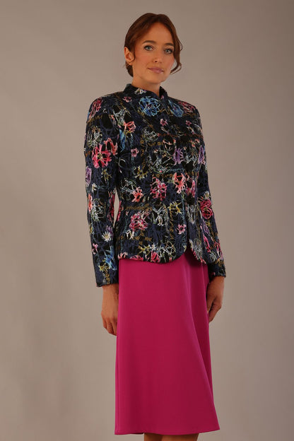 The Keanu floral jacket layered over a pink A-line dress for an elegant occasion look (Nightshade Bloom)