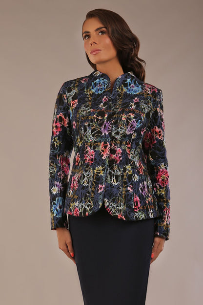 The Keanu floral jacket layered over a pink A-line dress for an elegant occasion look (Nightshade Bloom)