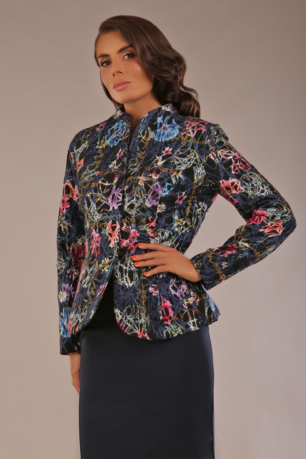 The Keanu floral jacket layered over a pink A-line dress for an elegant occasion look (Nightshade Bloom)