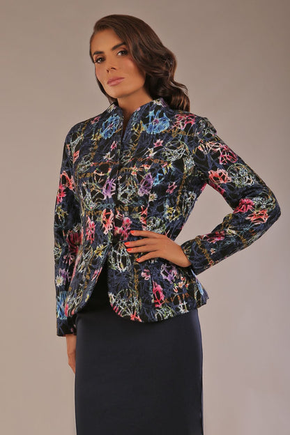 The Keanu floral jacket layered over a pink A-line dress for an elegant occasion look (Nightshade Bloom)