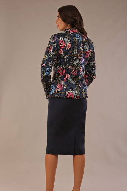 The Keanu floral jacket layered over a pink A-line dress for an elegant occasion look (Nightshade Bloom)