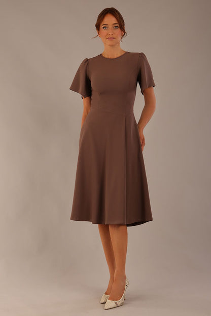 Model wearing a diva catwalk Anders petal sleeve A-line dress against a plain background (Peppercorn Brown)