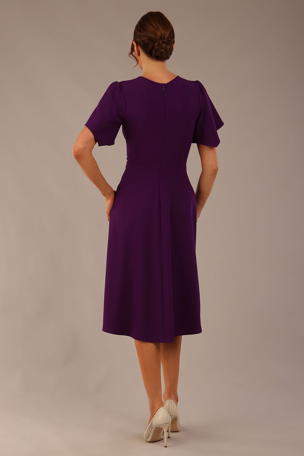 side view Model wearing a diva catwalk Anders petal sleeve A-line dress against a plain background (Purple)