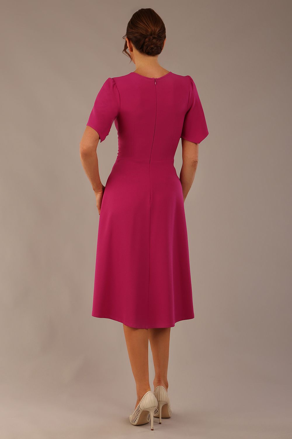 side view Model wearing a diva catwalk Anders petal sleeve A-line dress against a plain background (Magenta)