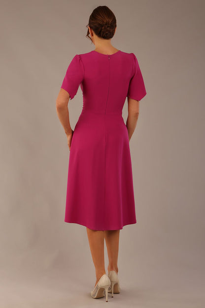 side view Model wearing a diva catwalk Anders petal sleeve A-line dress against a plain background (Magenta)