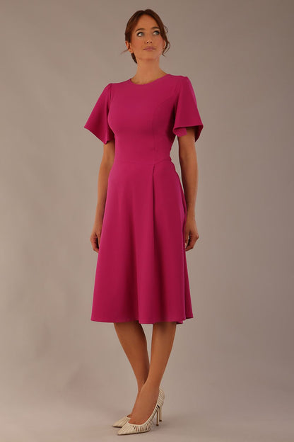 side view Model wearing a diva catwalk Anders petal sleeve A-line dress against a plain background (Magenta)