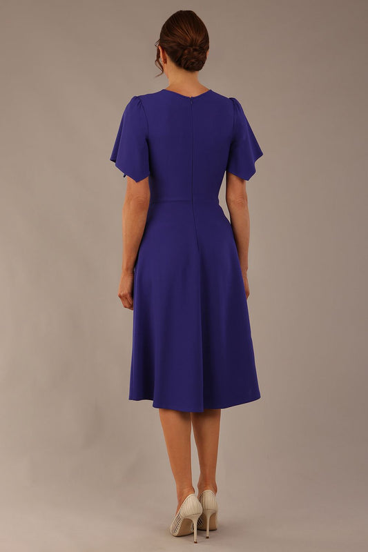 Model wearing a diva catwalk Anders petal sleeve A-line dress against a plain background (Spectrum Indigo)