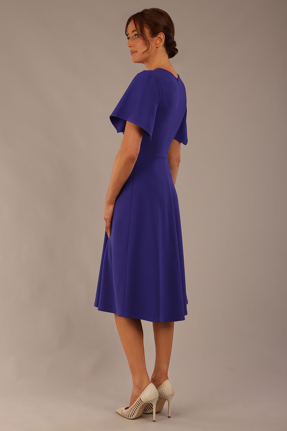 Model wearing a diva catwalk Anders petal sleeve A-line dress against a plain background (Spectrum Indigo)