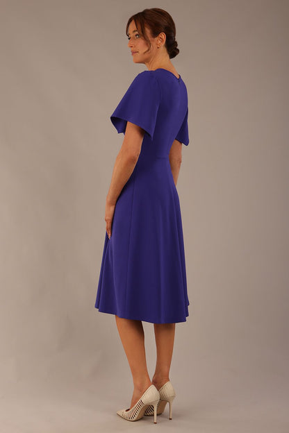 Model wearing a diva catwalk Anders petal sleeve A-line dress against a plain background (Spectrum Indigo)