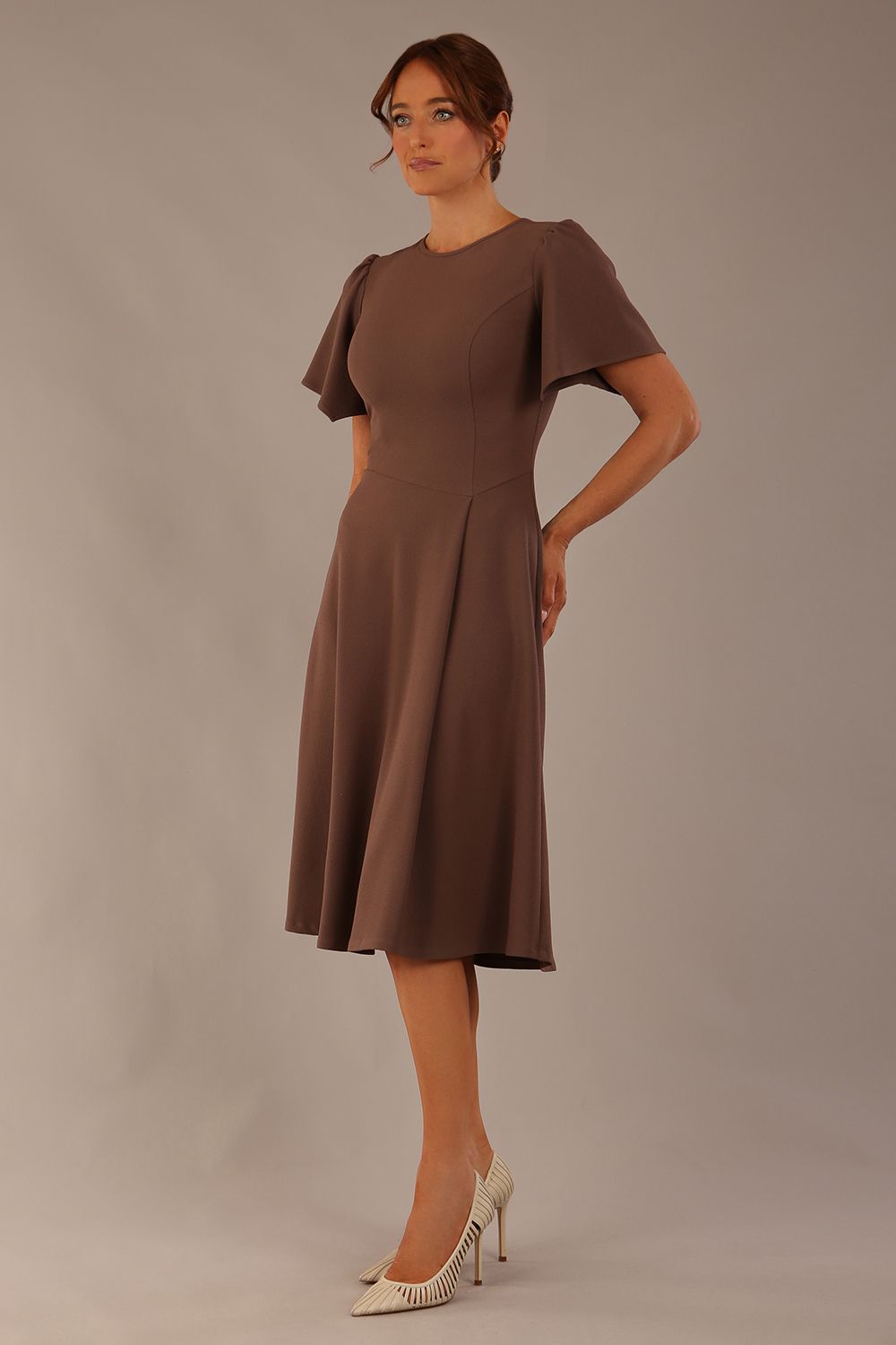 Model wearing a diva catwalk Anders petal sleeve A-line dress against a plain background (Peppercorn Brown)